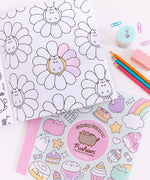 Back cover of the Coloring Cuteness: A Pusheen Coloring & Activity Book. The mint-colored background has a pattern of pastel graphics of Pusheen climbing an ice cream cone, Pusheen as a ghost, Pusheen as a strawberry milk carton, a teapot, candy, and more. The book has a light pink spine and contains a description of activities and coloring pages you’ll find inside the book. Print on the bottom of the cover is the publisher, a UPC code, and pricing information.