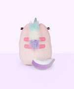 Quarter view of the Dreamy Pusheenicorn Squisheen facing the left in front of a light purple background. The white cloud on the front is more visible from this angle, though the multicolor mane is only visible directly behind Dreamy Pusheenicorn’s horn.