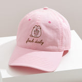 Sunlight shines on the Pusheen Cap to show off the light pink color of the cap. 