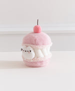 Alternate side quarter view of the Pusheen Sweets Cherry Macaron Environment. The white, pink, and medium pink plush has a removable miniature plush of Pusheen the Cat.  