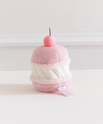 Side back view of the Pusheen Cherry Macaron Plush. White filling is sandwiched by two light pink cookies. 