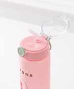 Pink pusheen water bottle is a vertical graphic down the center back of the Sweets Water Bottle. Pusheen transforms into light pink, white, green, and medium pink macarons. 