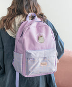 The back view of the Pusheen backpack. The top carrying hoop and tightening buckles are a light purple color while the arm straps are a different purple color that matches the backpack itself. On the back of the backpack is a subtle triangle embroidery. 