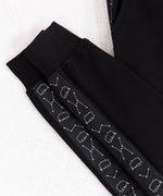 Front view of the Pusheen Celestial Jogger, hanging from a white clothes hanger in front of a white background. The pattern on the side is not visible from the front, making the item appear like a solid black jogger.