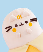 Banana Plush sits in a white wire basket. The yellow Pusheen shows Pusheen as a banana fruit with a dark yellow peel.
