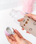 Packaging of glass water bottle. Cardboard packaging features blue, pink, and white graphics with a picture of the water bottle inside on the front.  