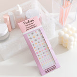 Sweets and savory snacks nail sticker set rests on a desktop. The set includes stickers of Pusheen the cat. 
