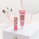 Hand lotion and Pusheen lip balm sit on a vanity. The set has pink packaging and is small enough to carry in a purse. 