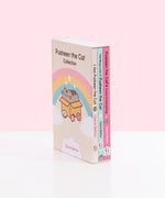 I Am Pusheen the Cat, The Many Lives of Pusheen the Cat, and Pusheen the Cat's Guide to Everything Paperback books stacked atop one another inside the decorative book box. Books lie upside down inside the box to show the spine graphics and portions of the back covers of each book.  