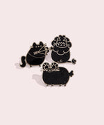The Sagittarius, Leo and Aries pin arranged together on top of a light pink background.